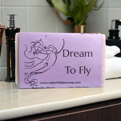 dream to fly vegan bar soap, purple wrapper with a woman floating graphic