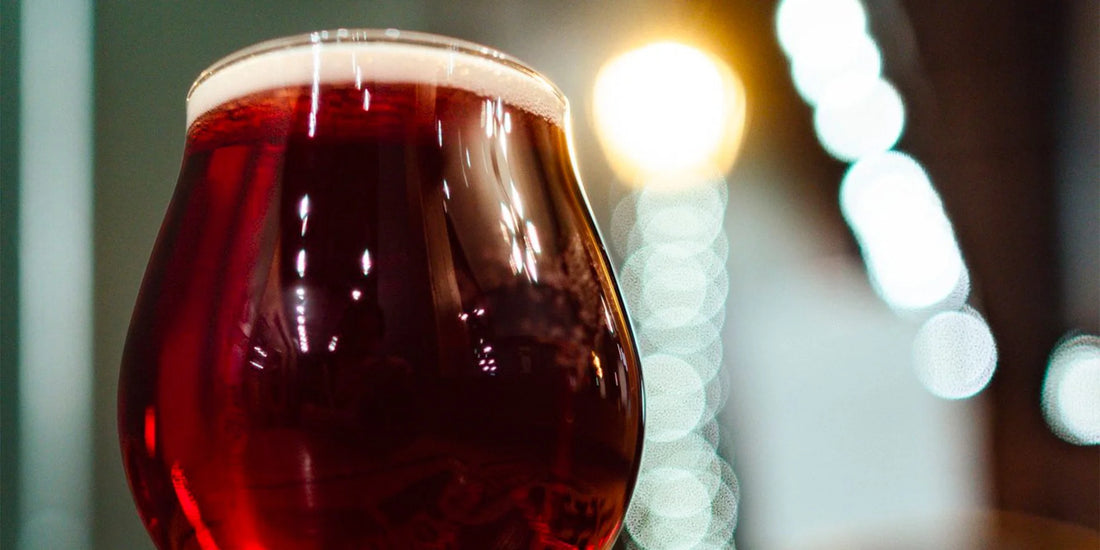 a glass of tap beer with a dark red color