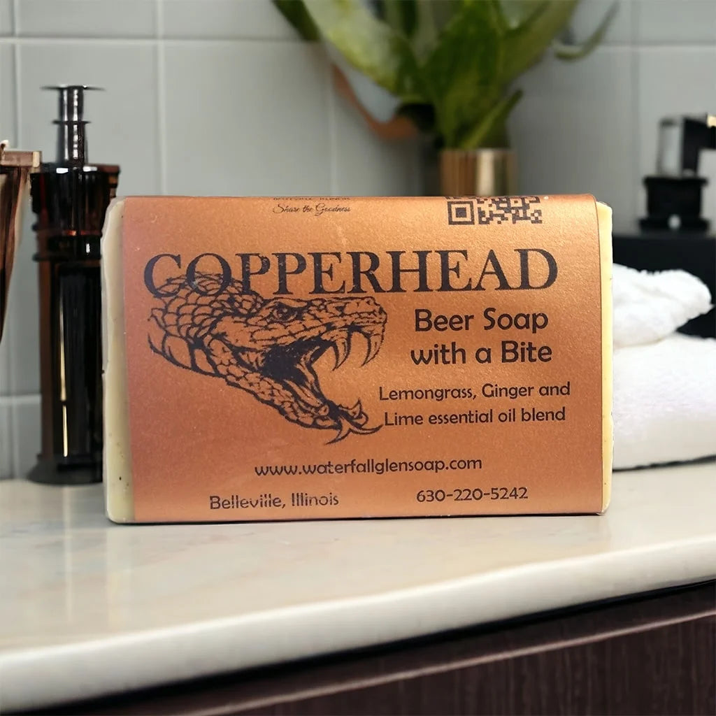 copperhead bar soap, an orange soap wrapper with the title of the soap and a graphic of a snake on the front