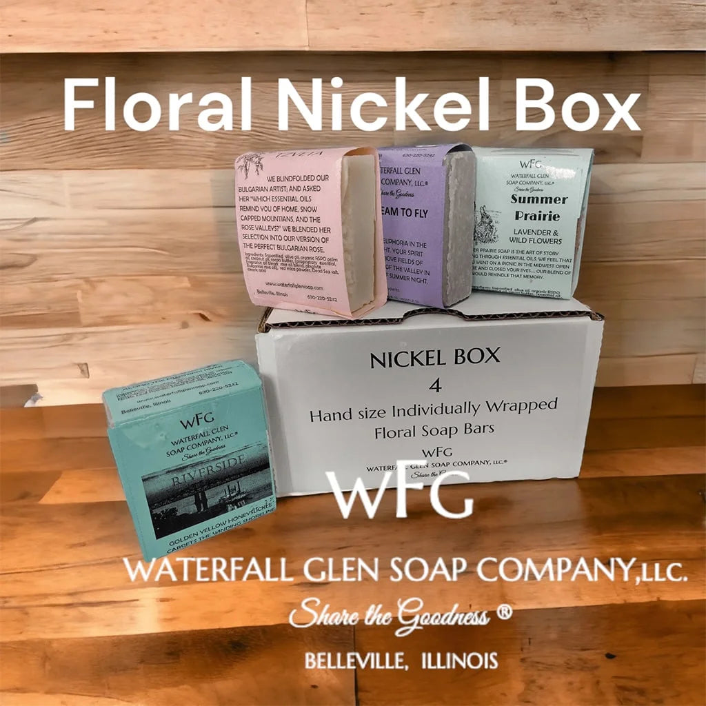floral scented nickel box of four bar soaps on top of the packaging container on a wooden table