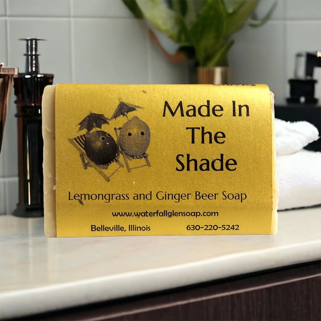 made in shade soap with a yellow wrapping showing the front side with graphics of lemons under umbrellas