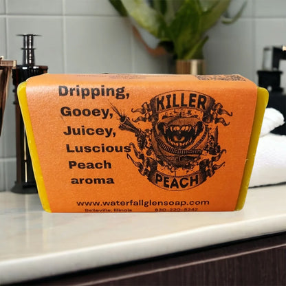 peach tree vegan bar soap, orange wrapper, front view, with a graphic of monster teeth grinning and a banner surrounding it saying Killer Peach