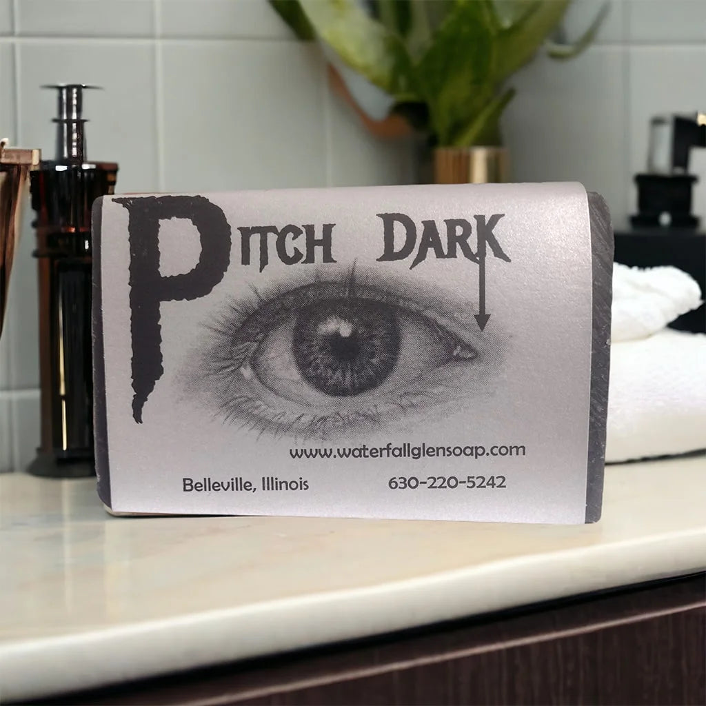 pitch dark vegan bar soap, white wrapper with an eye graphic