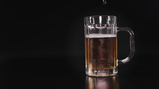 Beer in a beer glass on a table with a dark background, transitioning to people studying and cleaning on a nice bright day, then transitioning to the Made In The Shade bar soap.