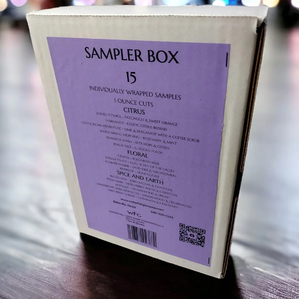 Sampler box with cardboard packaging and a purple label with black text sitting on a wooden table.